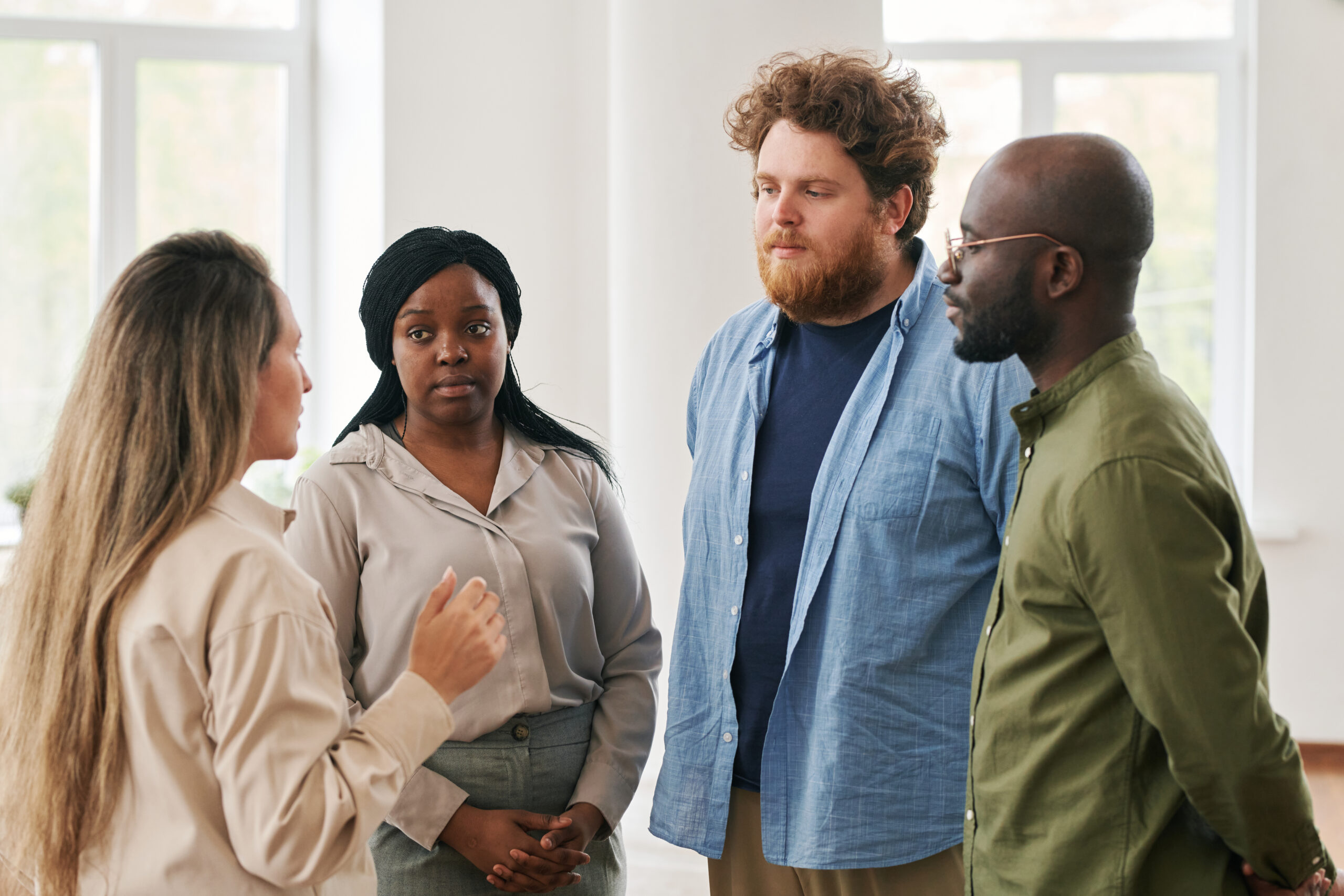 Group of young interracial people attending course of psychological help
